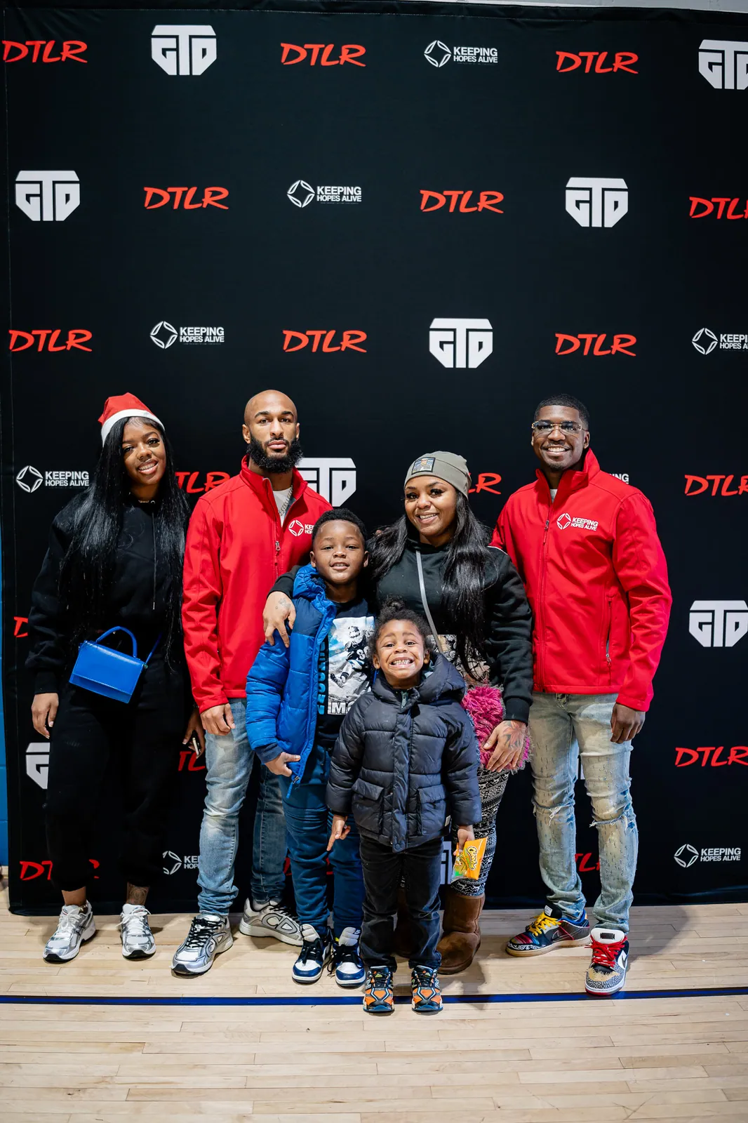 Adults and children together at the KHA holiday event photo wall