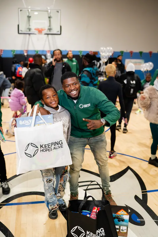 A KHA staff member with a child at the holiday drive
