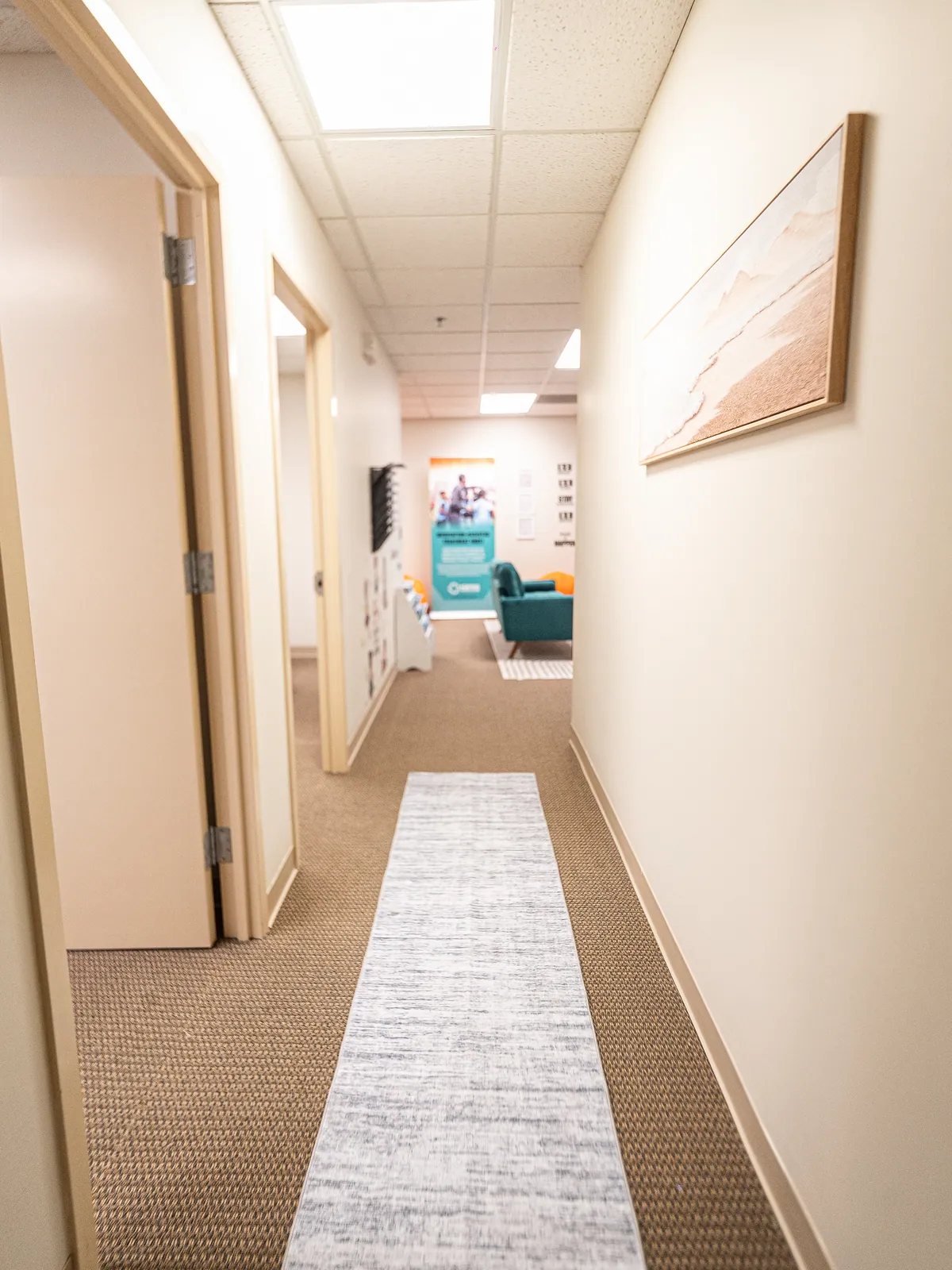 A bright hallway leading to therapy offices at the KHA clinic