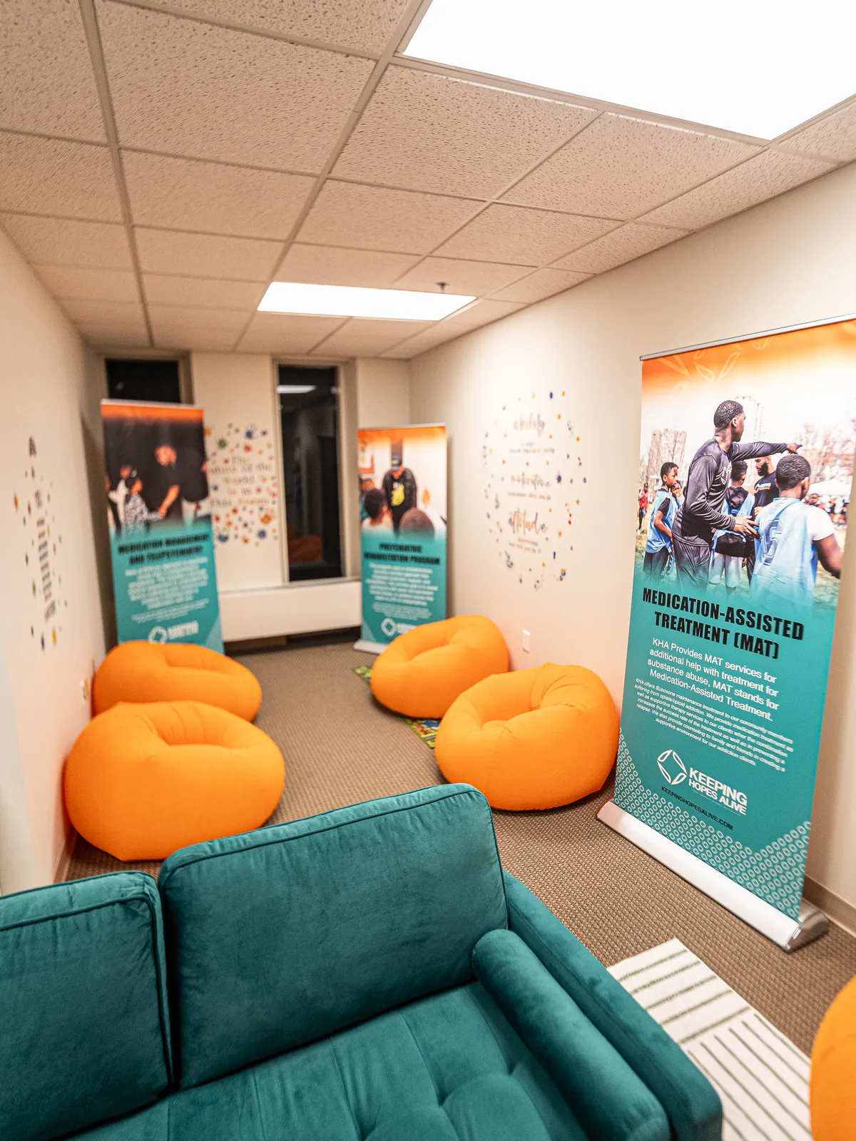 Clinic lounge with orange bean bag chairs and MAT program information banners