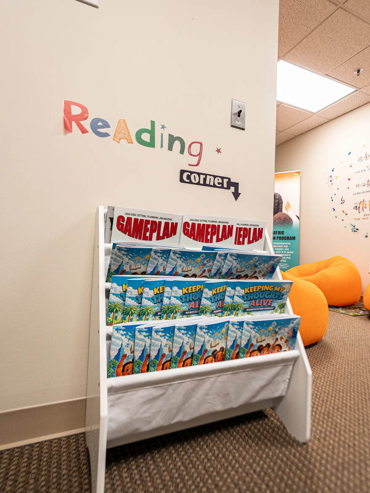 Reading corner with books and orange bean bag seating