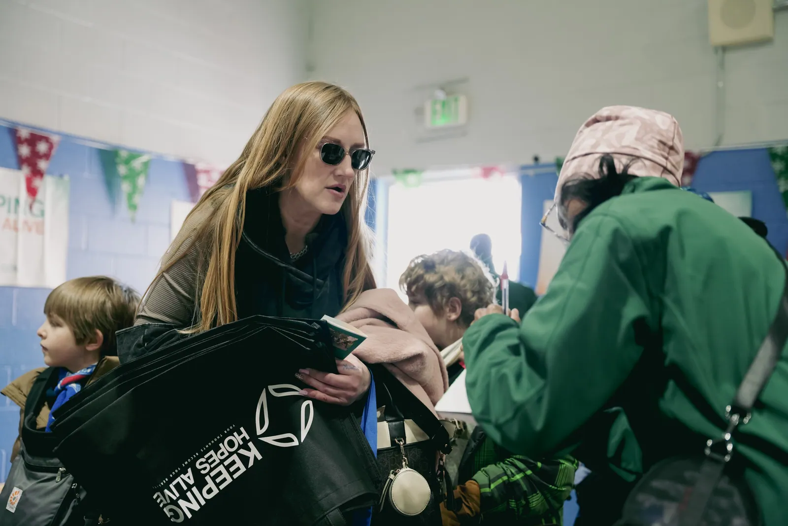 Volunteers handing out coats and gifts at the KHA holiday drive