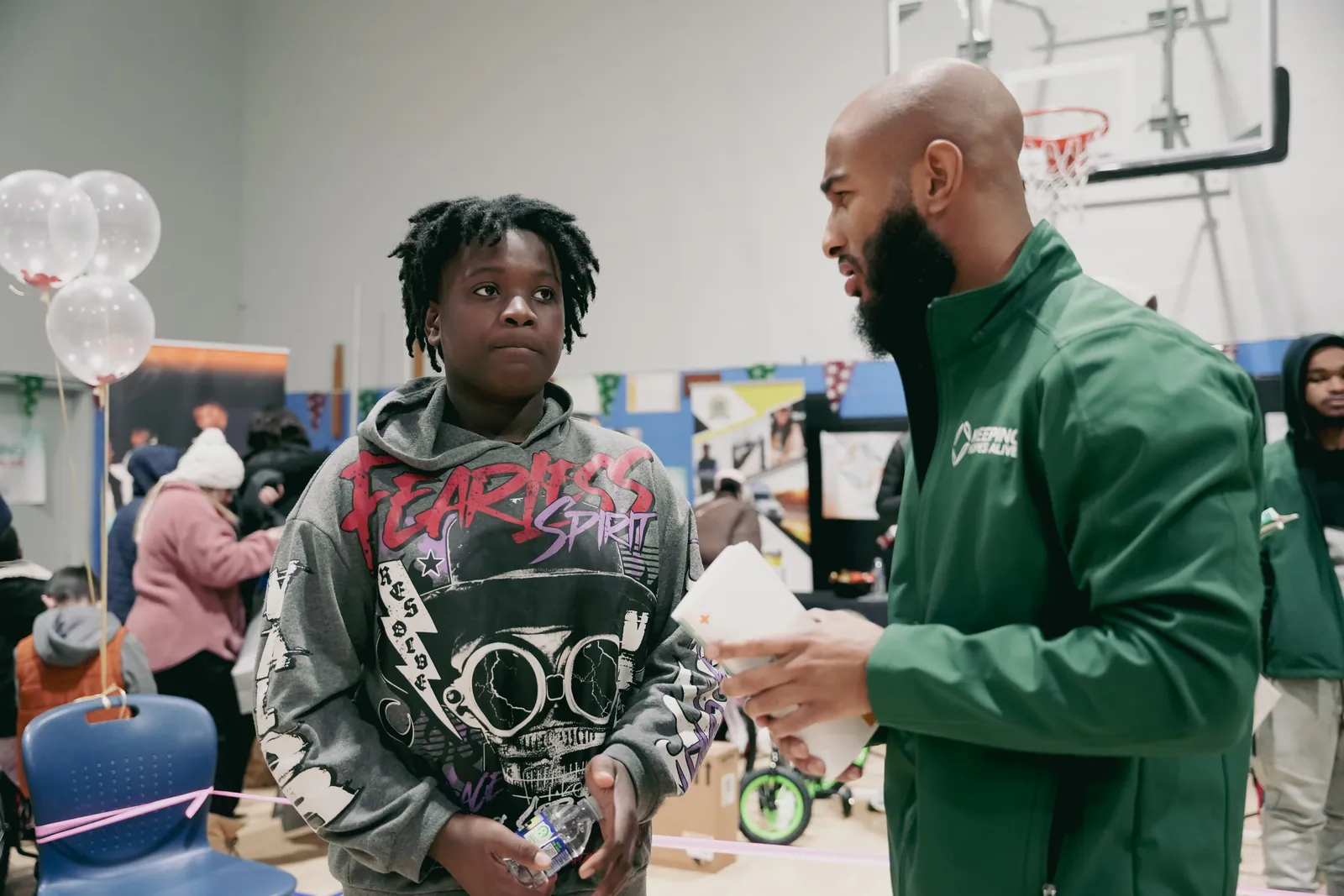 A KHA staff member greeting a young person at the holiday drive