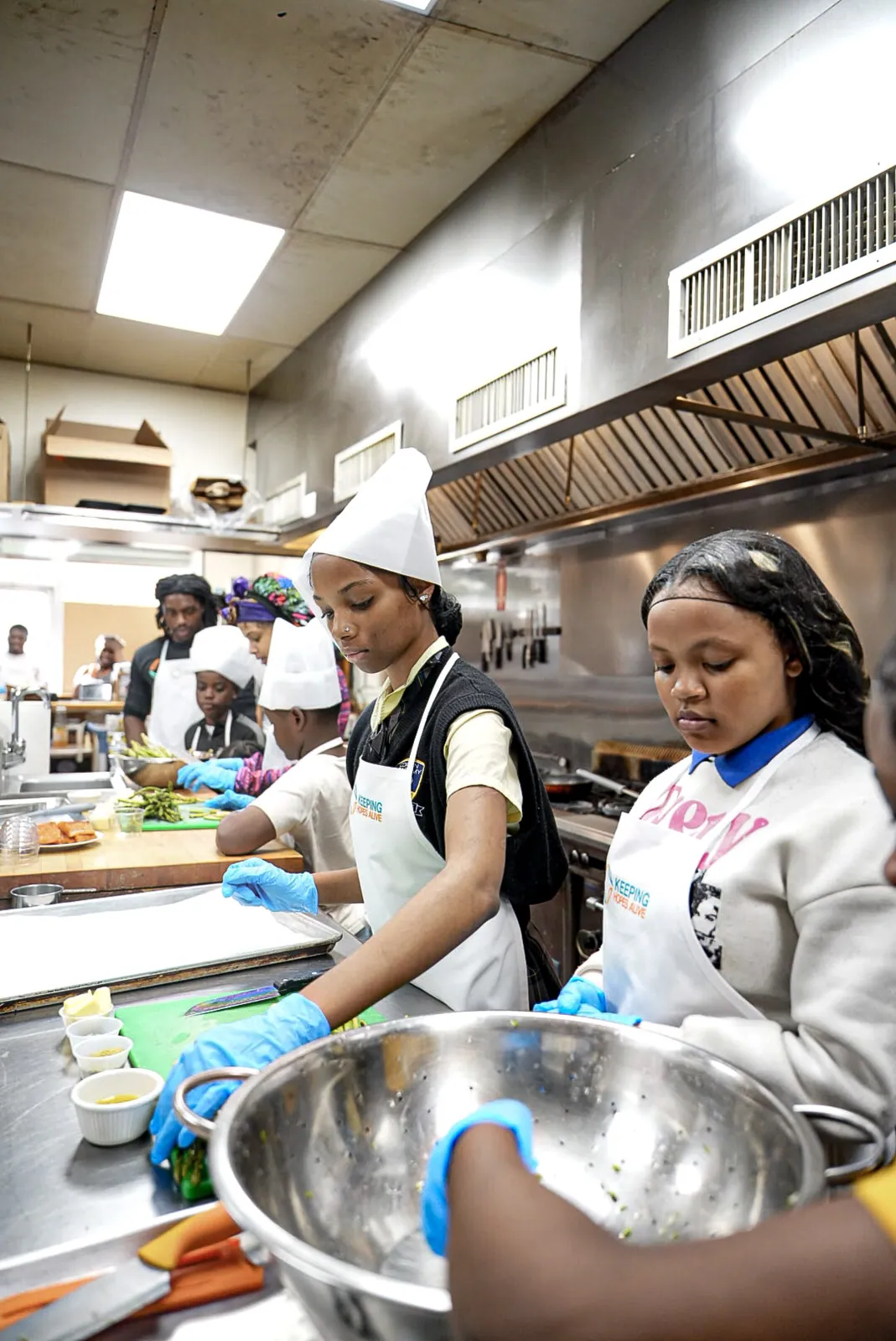 KHA youth cooking together in a commercial kitchen