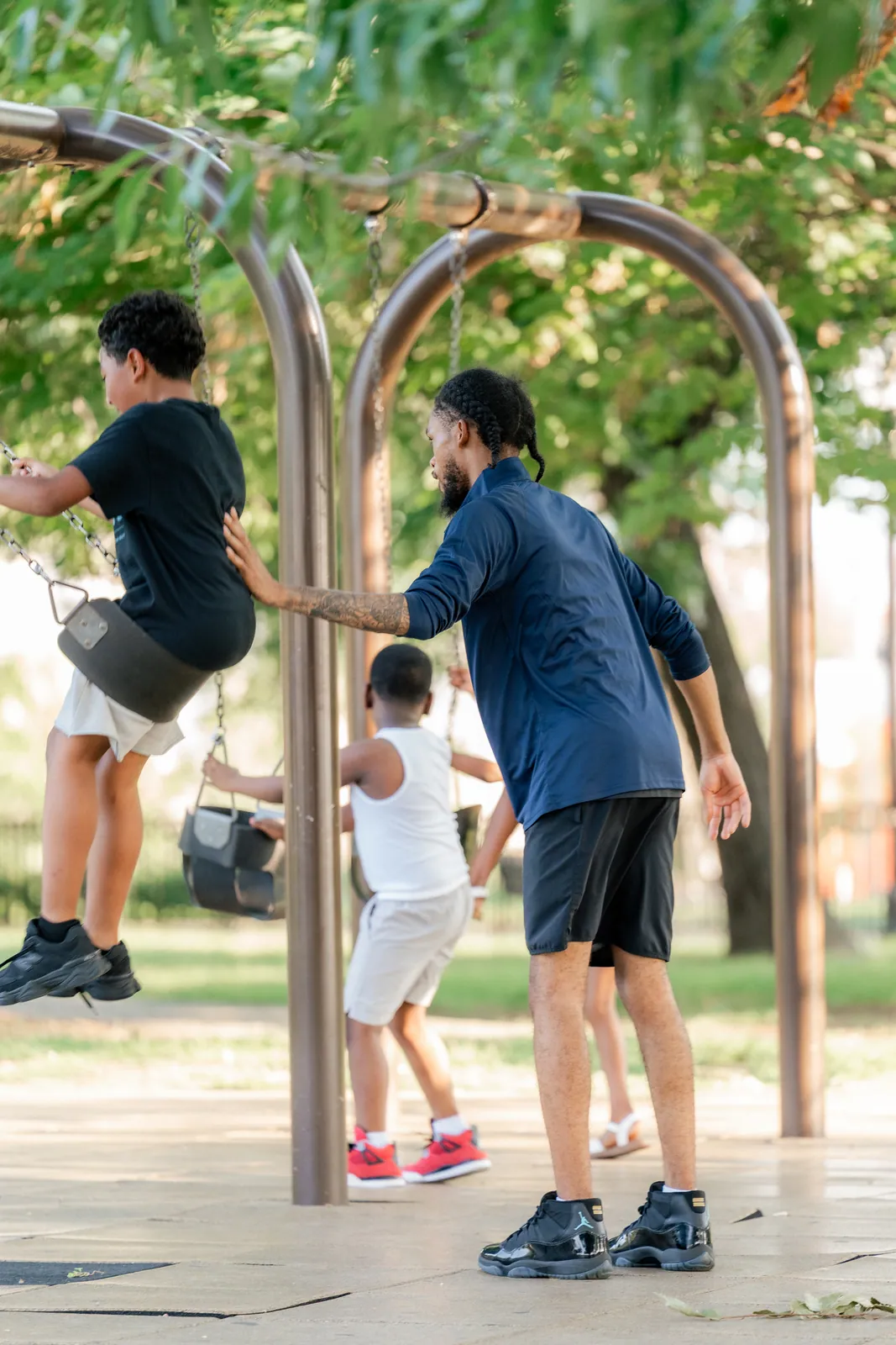 A KHA mentor playing with kids on a playground
