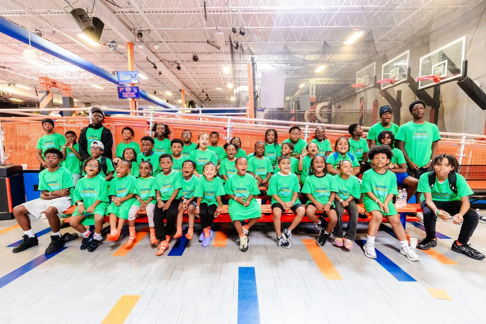 KHA Summer RISE youth and staff seated together at Sky Zone