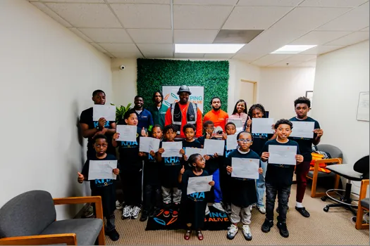 KHA youth holding certificates with staff in the Keeping Hopes Alive office