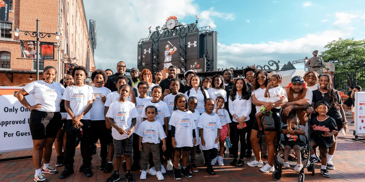 KHA youth and staff in matching white shirts outside a Baltimore ballpark
